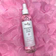 Rosewater on a bed of rose petals