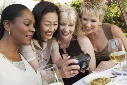 four female friends looking at camera