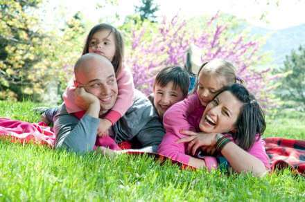 family sitting in the grass