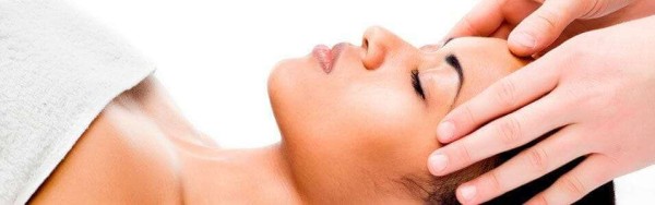 facial massage to female lying down