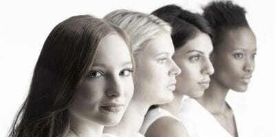 Four females with one looking at camera