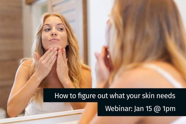 How to figure our what your skin needs image - female looking at her skin in a mirror