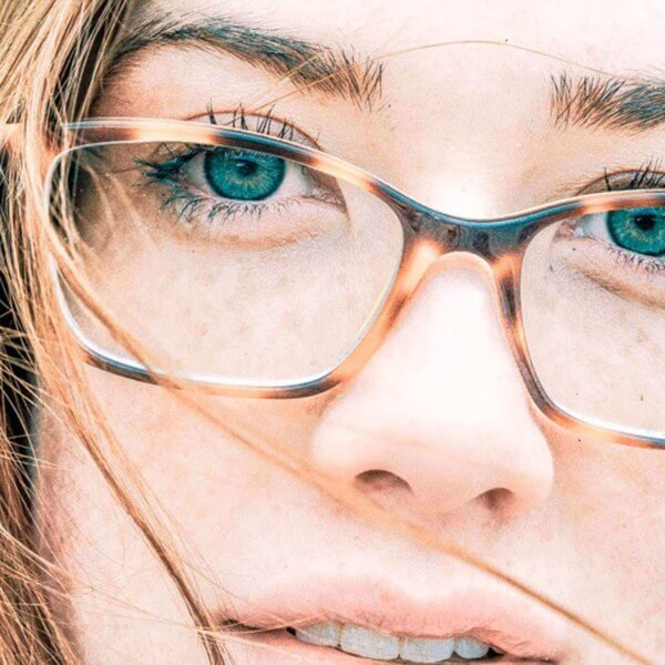 Close up of freckled beauty with glasses