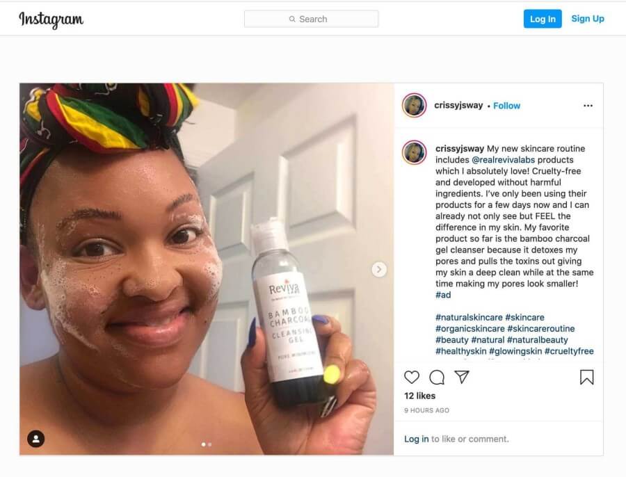 crissyjsway holding charcoal cleanser and foam on her face and cheeks