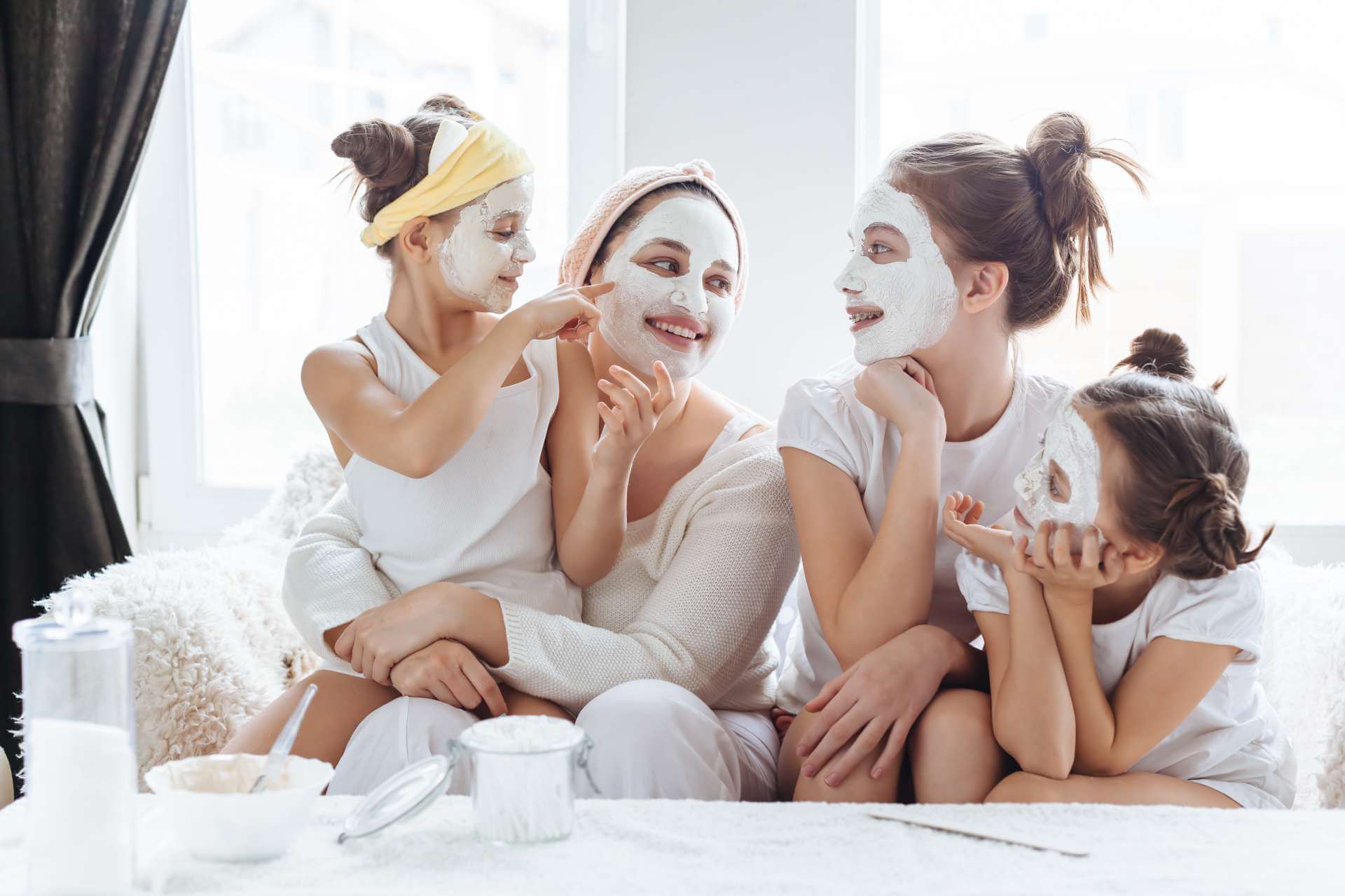 mom with daughter using skin care masks