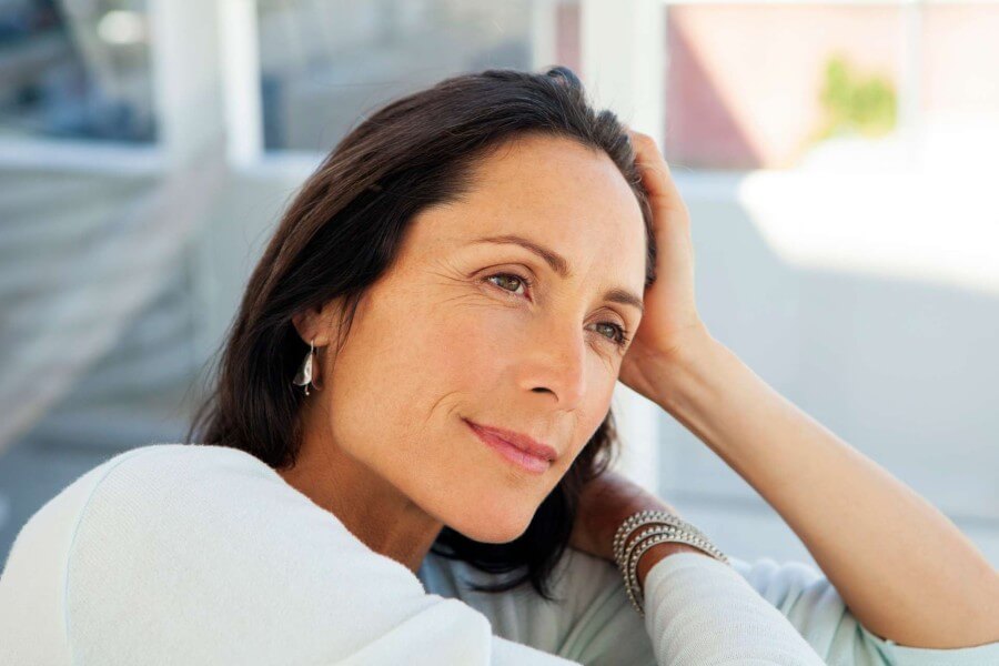 woman looking away - beautiful pensive middle aged person - close up portrait