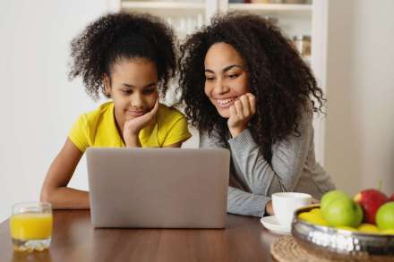 indoors-childhood-smiling-family-mother-home-daughter-laptop-together-using-technology_t20_pLdb2O