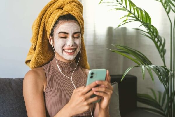 young-woman-using-mobile-smartphone-while-having