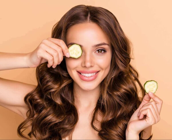 charming wavy haired girl close her eyes with cucumber slices want have vegetable vitamin treatment