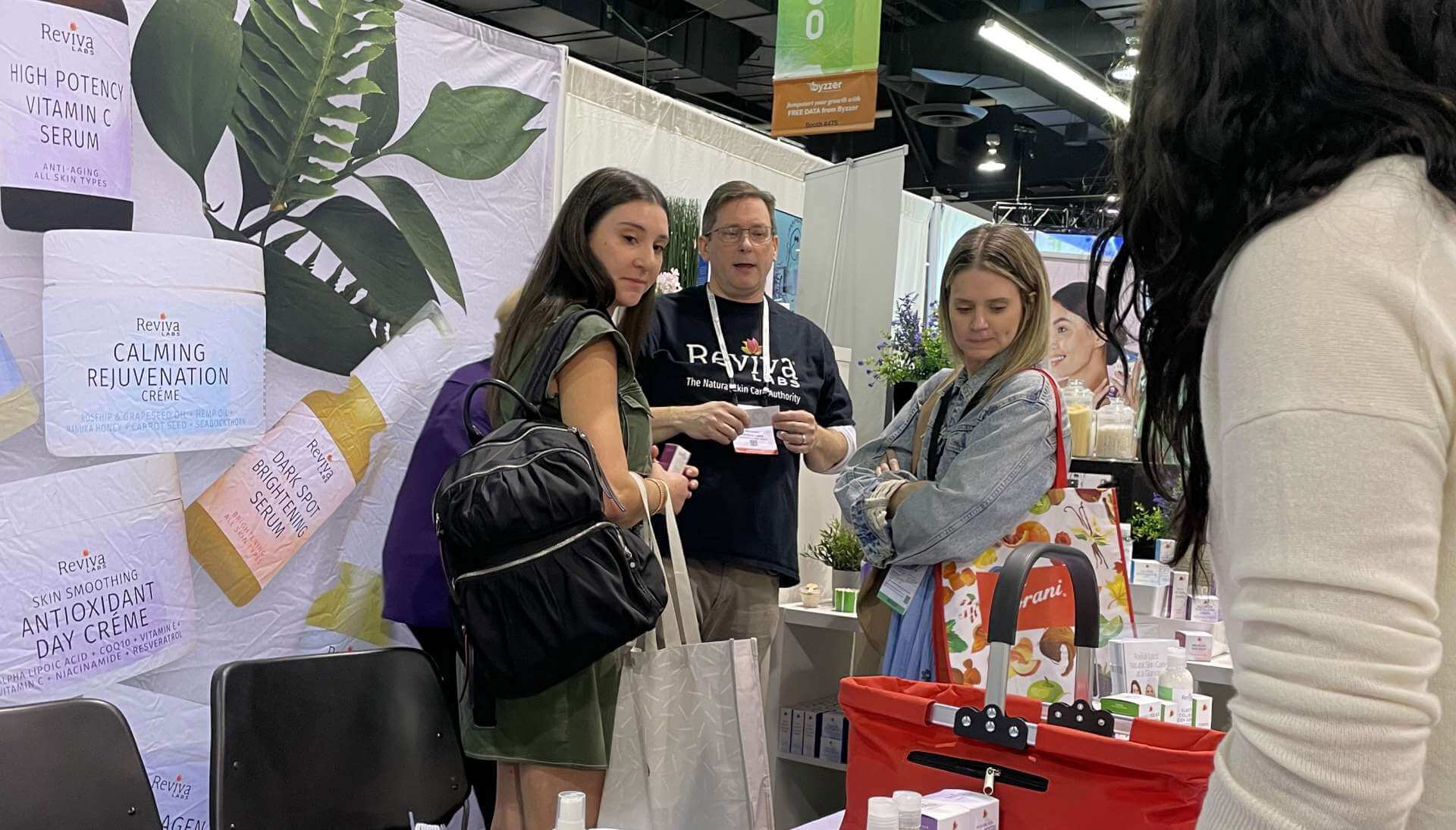 Bill Levins working the booth at Expo West 2023 with Nancy Reimer