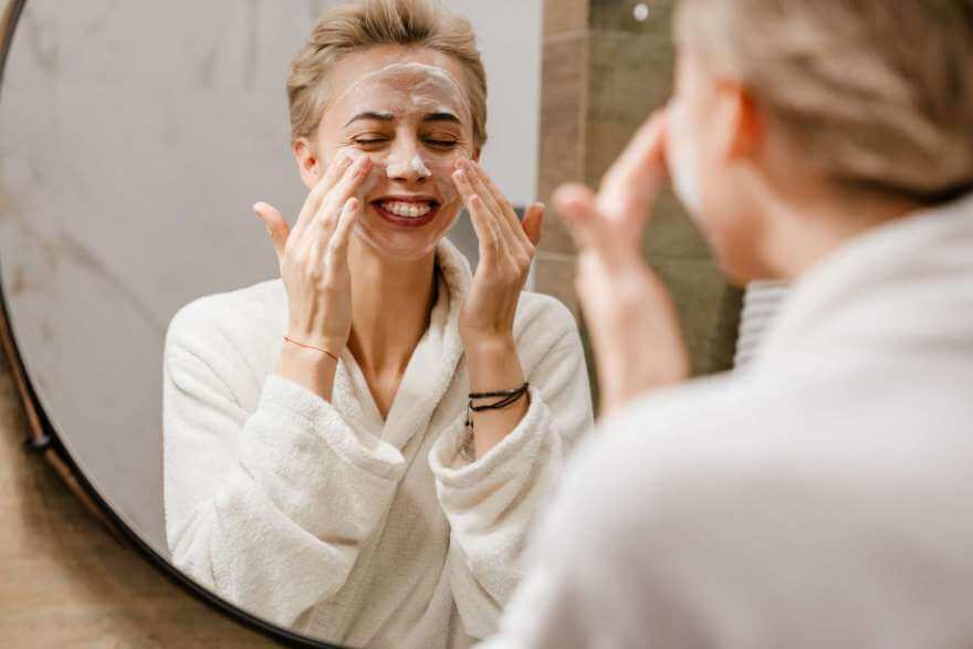 attractive young woman applying moisturizer on her 2021 09 02 02 38 23 utc