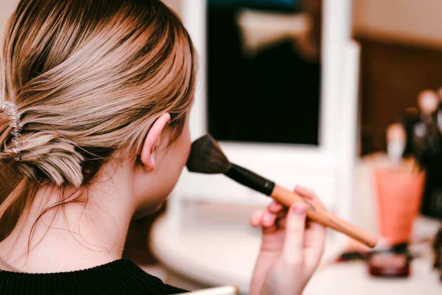 back view teenage girl applies makeup with brush 2021 08 26 19 57 33 utc