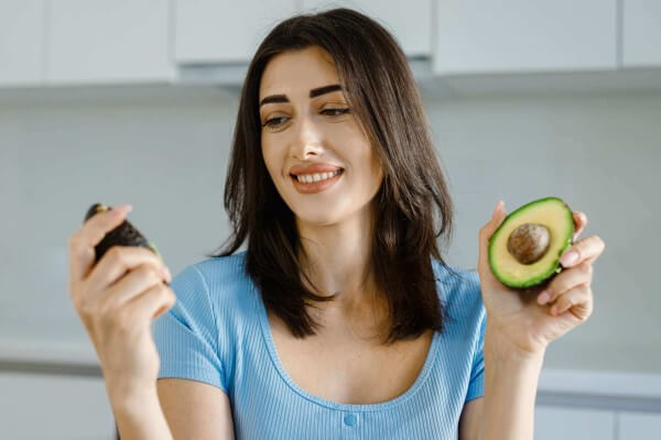 female nutritionist show avocado fresh vegetables 2022 11 17 16 31 31 utc