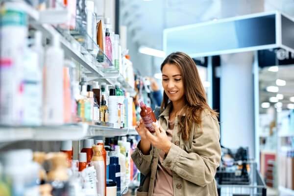 happy woman reading label on skin care product whi 2023 02 15 23 20 16 utc