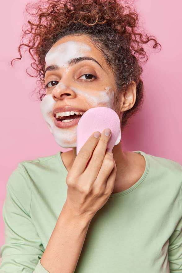 vertical shot of curly haired woman washes face wi 2023 05 04 00 55 12 utc