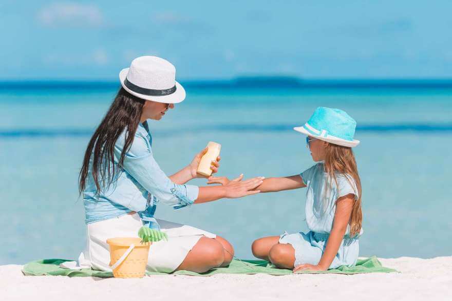 young mother applying sun cream to daughter nose o 2021 12 15 19 12 53 utc