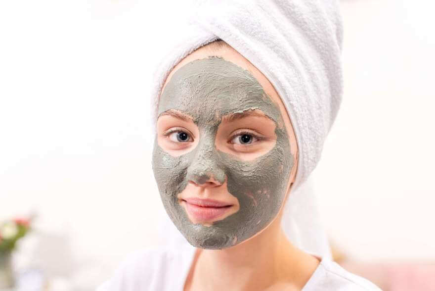 beautiful young woman with cosmetic clay mask at h 2022 12 16 16 35 20 utc