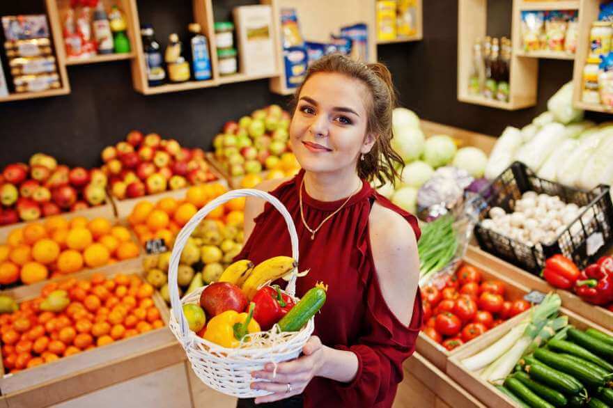 girl in red holding different fruit and vegetables 2022 02 08 16 22 02 utc