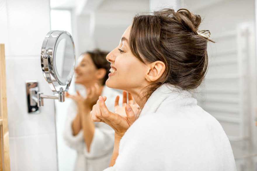 woman looking on her skin at bathroom 2021 09 01 20 43 49 utc