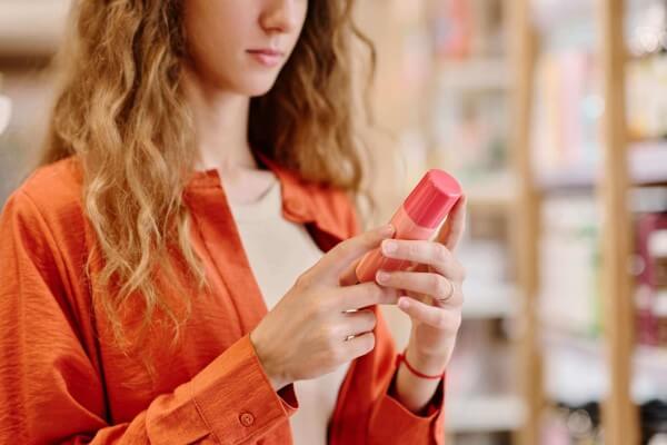 woman read label on cosmetic bottle 2023 07 14 23 38 49 utc