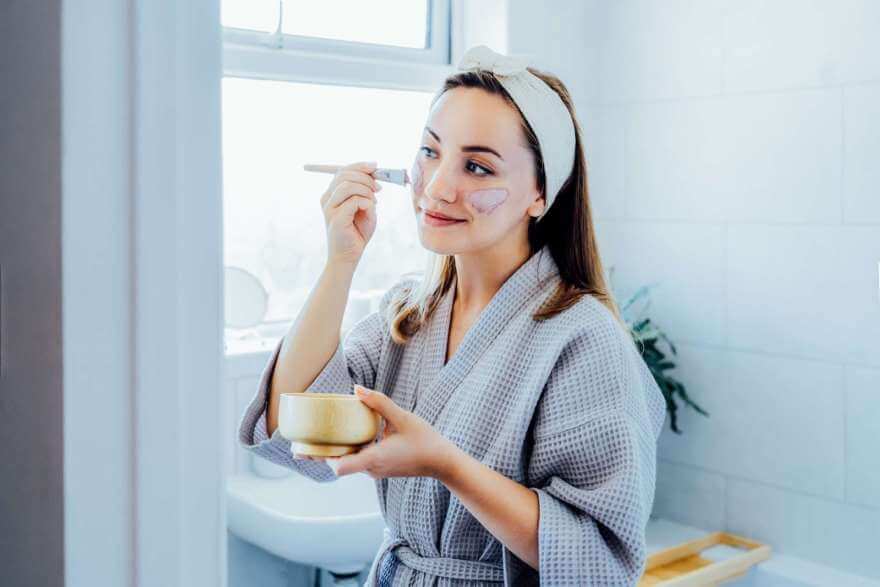 young woman in bathrobe looking in the mirror and 2022 11 08 04 56 08 utc