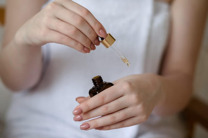 young woman applying serum from pipette 2022 11 16 19 18 04 utc