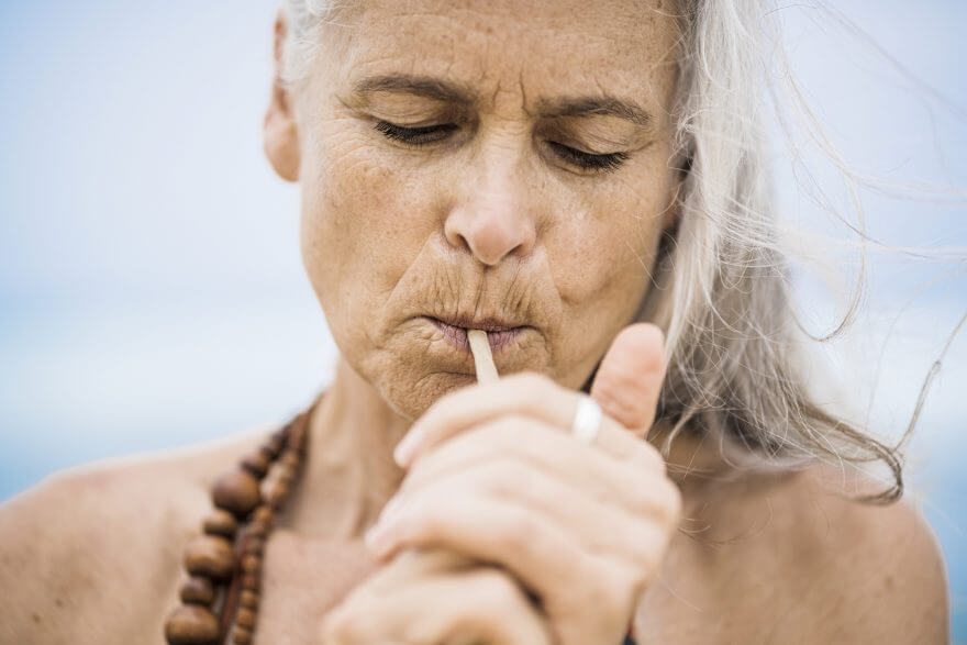 portrait of senior hippie woman smoking outdoors