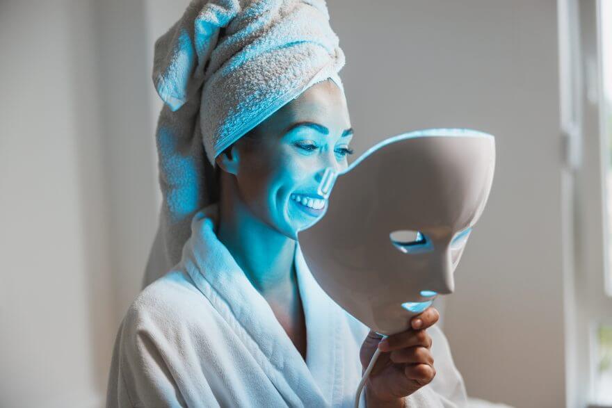 woman getting a led light facial mask treatment at the beauty salon