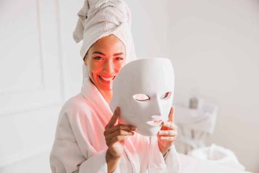 woman getting a led light facial mask treatment at the beauty salon