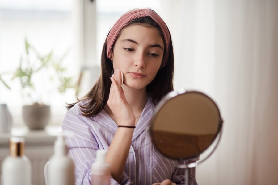 teenage girl doing her skin care routine.