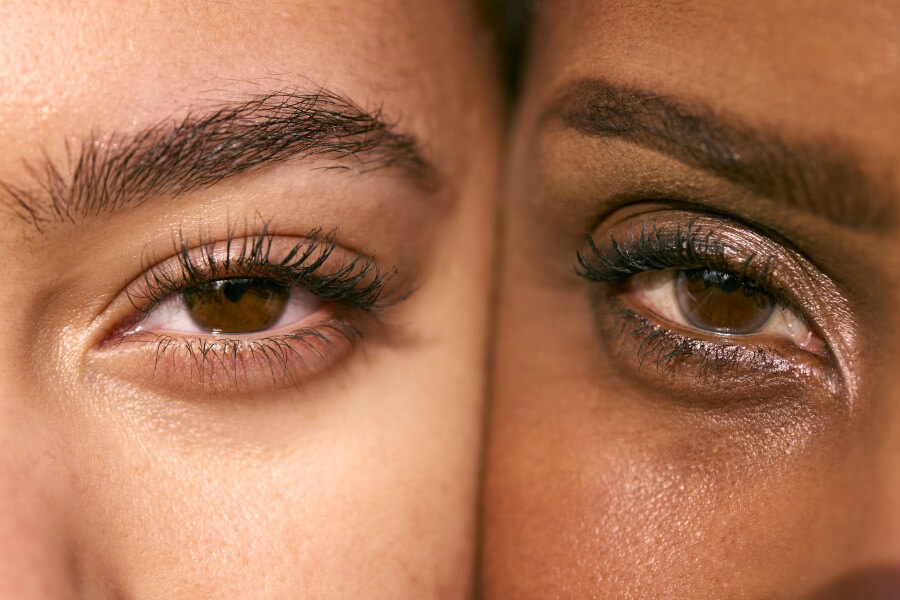 close up portrait showing eyes of mature mother with teenage daughter face to face