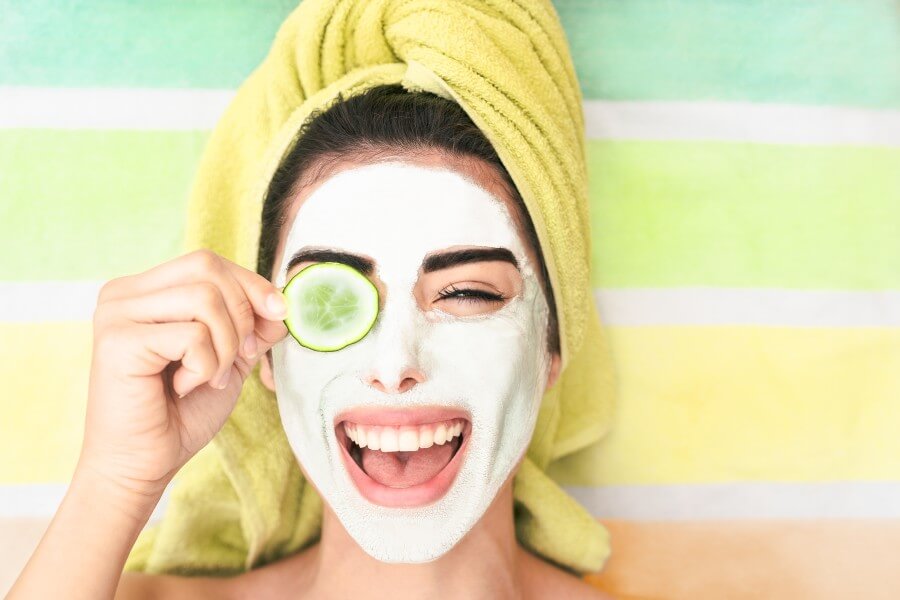 happy girl applying facial cleanser mask young woman having sk