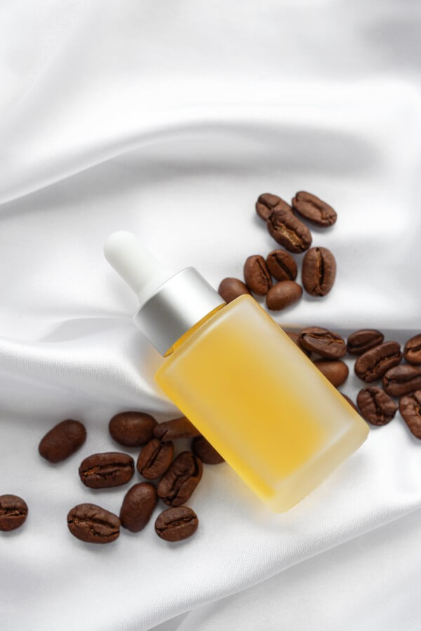 skincare caffeine eye serum. product bottle and coffee beans.