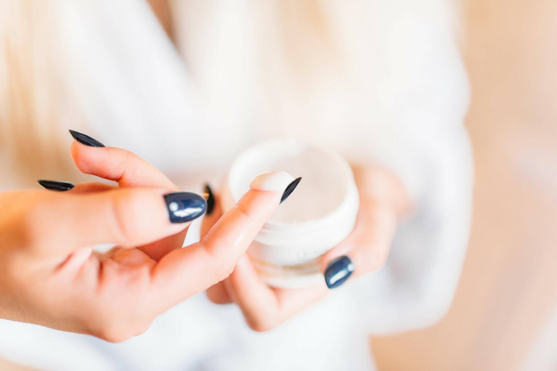 smiling female person in bathrobe, skincare