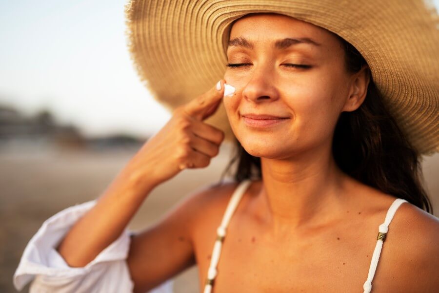 woman using sunscreen cream. beautiful girl with sun protection cream