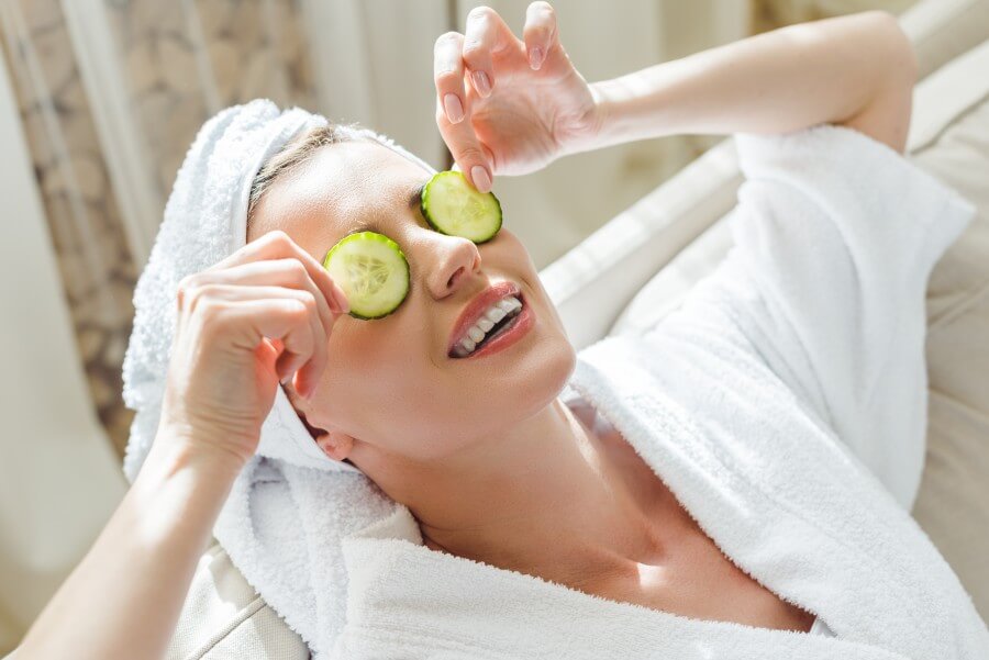 woman relaxing with cucumber slices on eyes