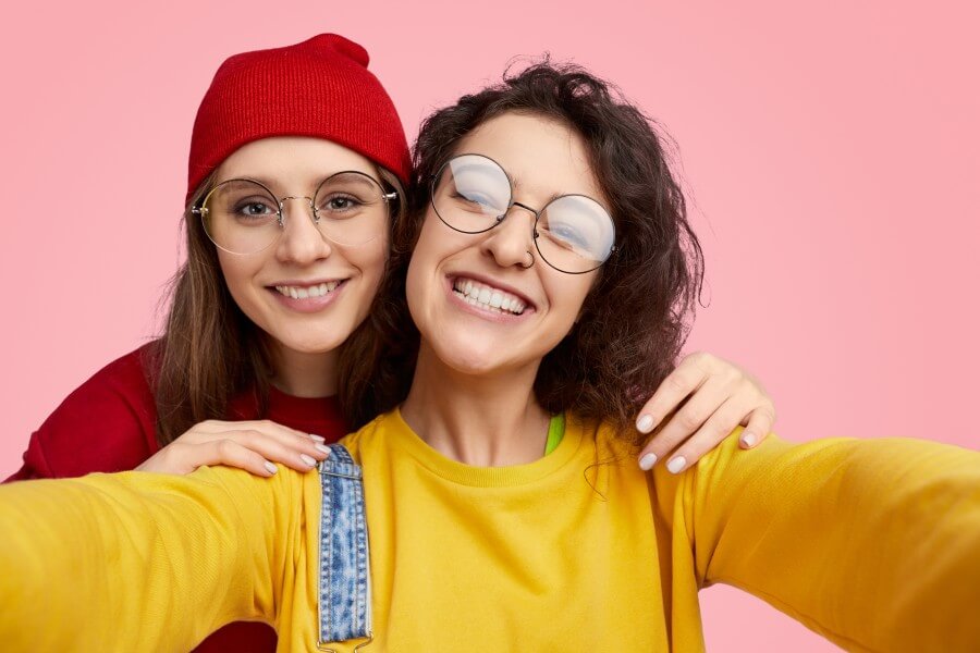 cheerful girls taking selfie