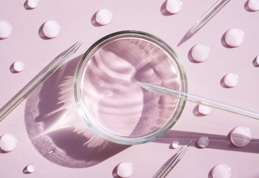 serum in petri dishes on light pink background cosmetic research concept