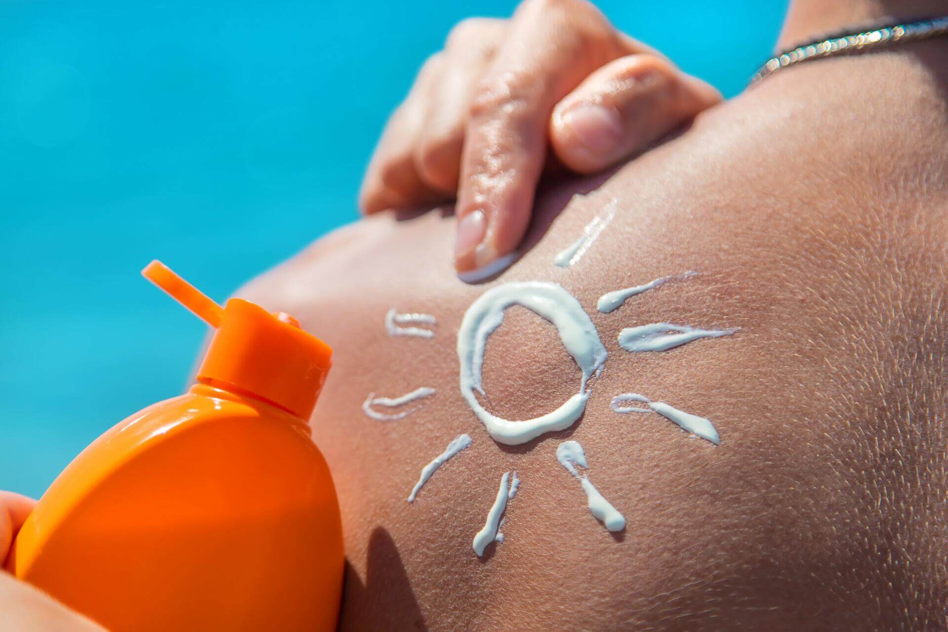 sunscreen on the man back. selective focus.