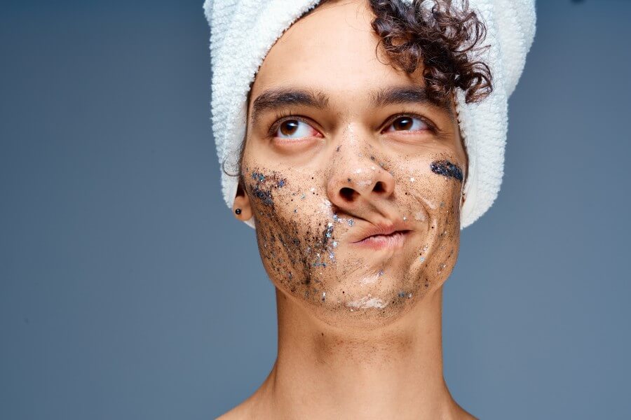 guy with a towel on his head cosmetics skin care close up