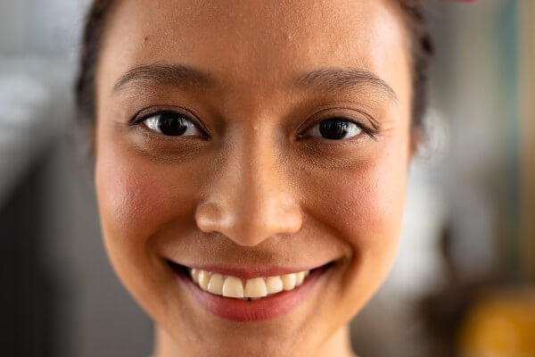 portrait of happy asian woman with tied hair at home. domestic life and lifestyle, unaltered.