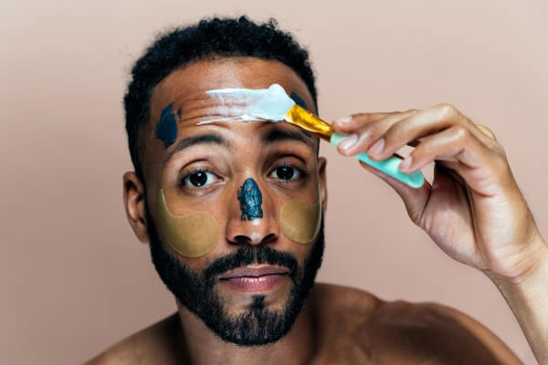 image of a young man taking care of his skin