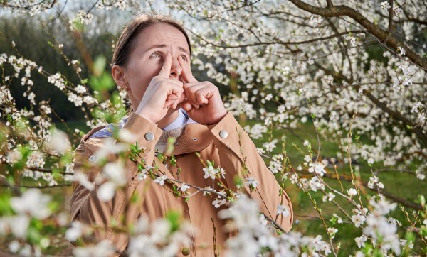 woman allergic suffering from seasonal allergy at spring.