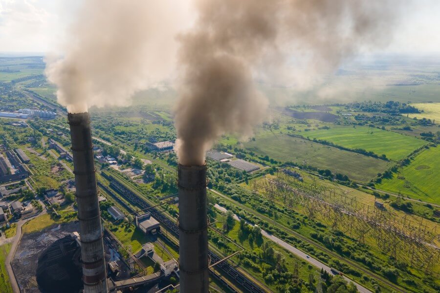 aerial view of coal power plant high pipes with black smokestack polluting atmosphere. electricity production with fossil fuel concept.