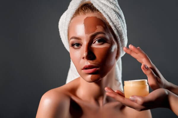 young woman with moisturizing facial mask.