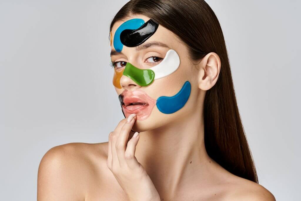 a young woman adorned with eye patches on her face, showcasing a symphony of colors in a mesmerizing display.