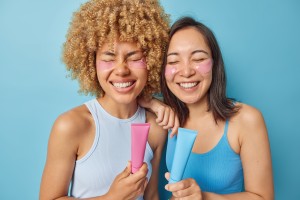 photo of cheerful women smile gladfully hold toothpaste have fresh breath after cleaning teeth dressed in casual t shirt foolish around and undergo hygiene procedures isolated over blue background