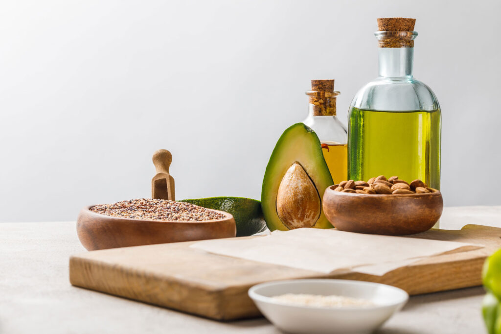 nuts and avocado on wooden chopping board near oil 2024 11 18 11 16 44 utc