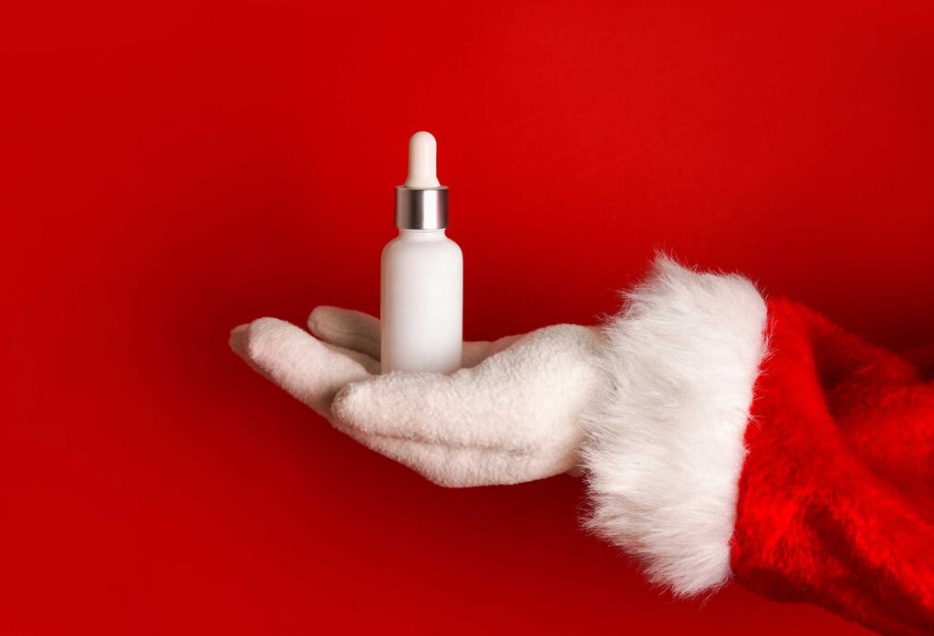 santa hand with dropper glass bottle mock up cosm 2023 11 27 04 53 27 utc