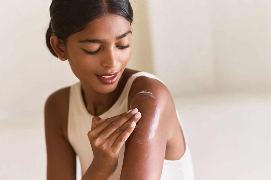 woman applying moisturizing lotion for healthy glo 2024 11 21 19 56 25 utc